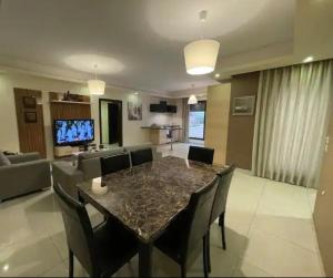 a living room with a table and chairs and a couch at Luxurious cozy apartment in Amman