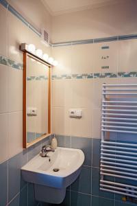 a bathroom with a sink and a mirror at U potůčku in Malá Morávka