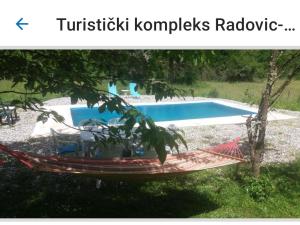 a hammock in front of a swimming pool at Turistički kompleks Radovic- Vila Lara in Tjentište