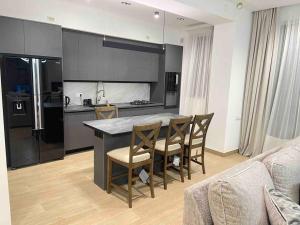 a kitchen with a table and chairs in a room at Fabulous Villa In Yerevan. in Yerevan