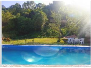 a group of white chairs sitting next to a swimming pool at Bungalovi Mihajlo & Miloš in Tjentište