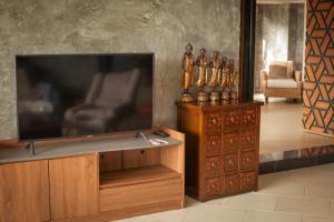 a flat screen tv sitting on top of a wooden entertainment center at Kata Prime in Kata Beach