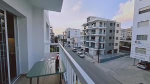 a balcony with a bench and a city street at STAY Sunlit Apartment in Limassol