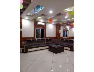 a large room with couches and a table and balloons at Hotel City Inn, Gaya in Gaya