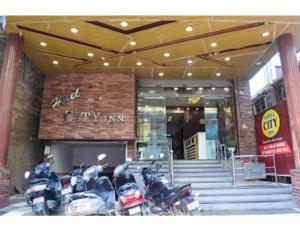 a group of motorcycles parked in front of a city inn at Hotel City Inn, Gaya in Gaya