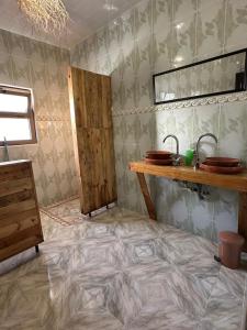 bagno con pavimento piastrellato, lavandino e bancone di DAR SANAE SURF ad Aourir Altre 37 foto