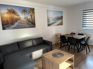 a living room with a couch and a table at Casa Estancia Apartment in Njivice