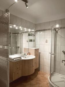 a bathroom with a sink and a shower and a tub at Cozy Appartement Belvaux in Belvaux