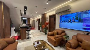 a lobby with a large screen tv in a building at White Pyramids inn in Cairo