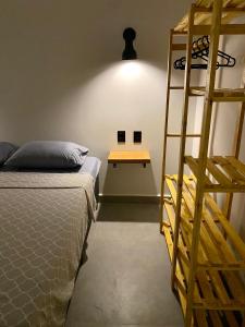 a bedroom with a ladder next to a bed and a table at Villa Julião in Ilhabela