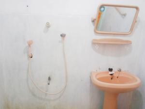 a bathroom with a shower and a toilet at Arachchi Guest House in Mirissa