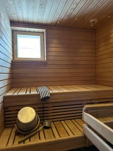 a sauna with a bench and a window at Captain's Square in Lahti