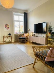 a living room with a flat screen tv on the wall at Trendy and light 2 room apartment in SoFo, 65sqm in Stockholm