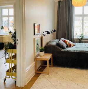 a bedroom with a bed and a table and a window at Trendy and light 2 room apartment in SoFo, 65sqm in Stockholm