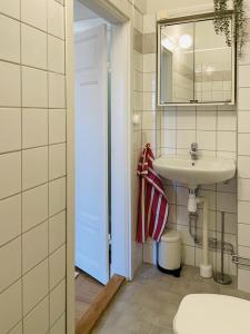 a bathroom with a sink and a mirror at Trendy and light 2 room apartment in SoFo, 65sqm in Stockholm