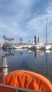 a boat in the water with boats in a marina at Orion in Le Barcarès