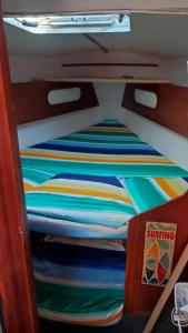 a bunk bed with colorful sheets in a room at Orion in Le Barcarès