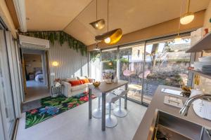 a kitchen and living room with a table in a room at Le Dourdou del traouc in Bozouls +20 photos