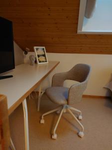 - un bureau avec une chaise et un ordinateur dans l'établissement Rivitalon lomahuoneisto Tahkolla, à Tahkovuori