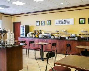 a restaurant with a counter with tables and chairs at Sleep Inn & Suites New Braunfels in New Braunfels