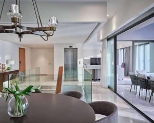 a dining room and living room with a table and chairs at Grand Hyatt Kuwait Residences in Kuwait
