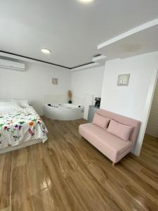 a bedroom with a bed and a bath tub in it at PLAYA POSTIGUET in Alicante