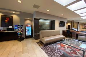 a waiting room with a chair and a drink machine at Wyndham Minneapolis South Burnsville in Burnsville