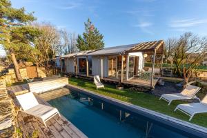 a home with a swimming pool and a house at Les Parenthèses Occitanes - L'Alrance del traouc in Bozouls