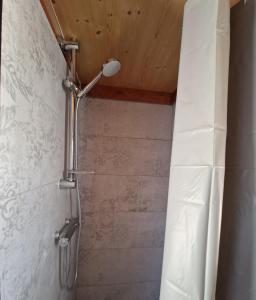 a shower in a bathroom with a shower curtain at Tiny House Loul Algarve no1 in Loulé