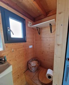 a bathroom with a toilet in a wooden cabin at Tiny House Loule Algarve in Loulé