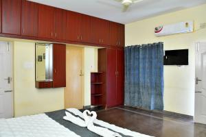 a bedroom with a bed with white shoes on it at Revive Inn Pondy - Rooms & Villa in Pondicherry