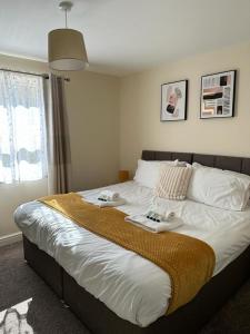 a bedroom with a large bed with two trays on it at Lovely 2-Bed Apartment in Stroud in Stroud
