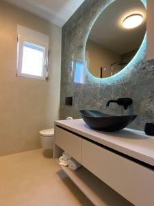 a bathroom with a black sink and a mirror at Luxury apartment with jacuzzi in Podstrana +27 photos