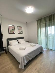 a bedroom with a large bed with two towels on it at Luxury apartment with jacuzzi in Podstrana