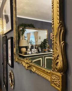 an ornate gold mirror hanging on a wall at Bohemian Chalet in Buşteni