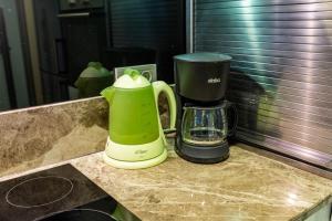 a green and black blender sitting on a counter at Chic Flat w Backyard 5 min to Akmerkez in Besiktas in Istanbul