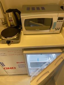 a microwave sitting on a counter next to a box at ماكس الفندقية 15 in Riyadh