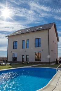 a house with a swimming pool in front of it at Sunrise Villa in Baile Felix