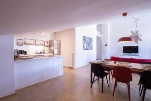 a kitchen and dining room with a table and chairs at Bright loft near Bohinj lake in Bohinj