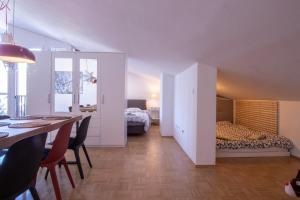 een kamer met een eettafel en een slaapkamer met een bed bij Bright loft near Bohinj lake in Bohinj