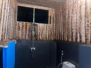 a bathroom with a shower and a toilet at Maweni CoralBay Beach Villa in Kilindoni