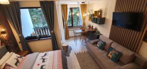 a living room with a couch and a table at FOX boutique apartment Borovets Gardens in Borovets