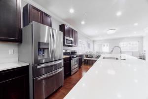 a kitchen with stainless steel appliances and a white counter top at Waterfront Gem Duplex 3 Bedroom 2Floor in Whitestone Bronx Free parking in College Point