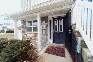 a house with a blue door and a fence at Waterfront Gem Duplex 3 Bedroom 2Floor in Whitestone Bronx Free parking in College Point
