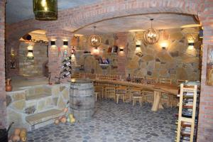 a room with a bar with a stone wall at Guest House Okropilauri in Shuakhevi