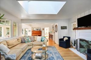 a living room with a couch and a table at Hammonds Beach Haven in Santa Barbara