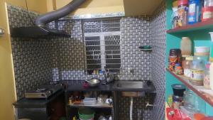 a small kitchen with a sink and a counter at Amullya Kanan Villa in Haldia