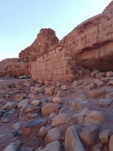 a rocky ground with rocks and a mountain at Rum Bedouin House in Disah