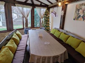 a living room with a table and a christmas tree at Guest House ViA in Sapareva Banya