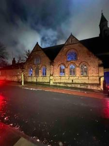 a brick building with blue lights in front of it at 4 Bedroom House, Central City Location in Newcastle upon Tyne